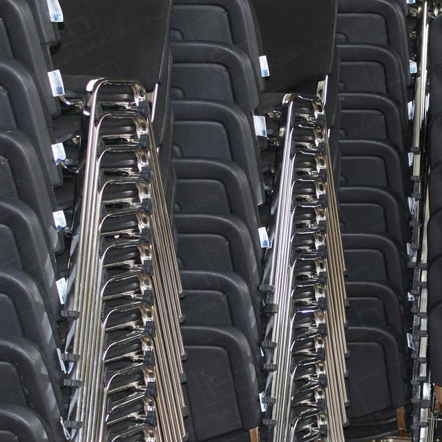 https://d1hcs5uofxldvl.cloudfront.net/furniture-hire-uk/article_additional/chapel3/chapel3.jpg - Stacks of our black conference chairs ready for installation.