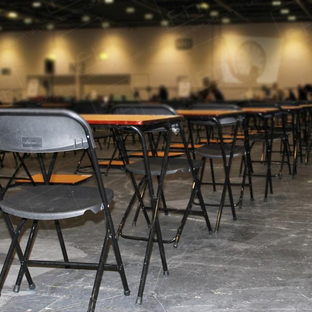 https://d1hcs5uofxldvl.cloudfront.net/furniture-hire-uk/article_additional/ucas-job2/ucas-job2.jpg - Thousands of exam tables ready for students.