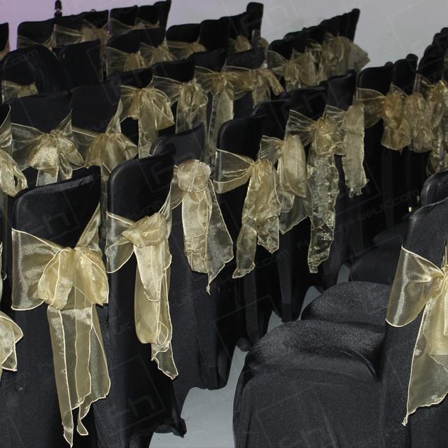 Wear It For Autism https://d1hcs5uofxldvl.cloudfront.net/furniture-hire-uk/article_additional/anna-kennedy-online13/anna-kennedy-online13.jpg - Banquet chairs with black covers and gold bows | HC108