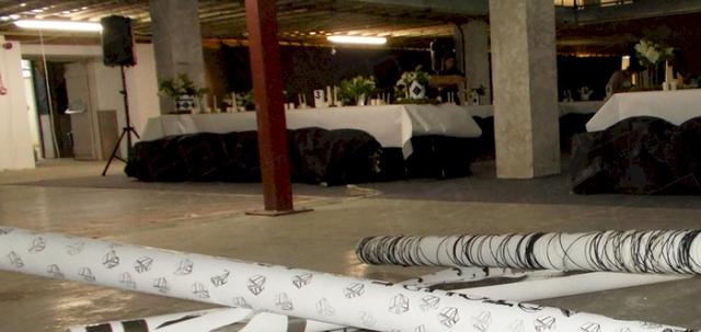 Art Launch with a Difference https://d1hcs5uofxldvl.cloudfront.net/furniture-hire-uk/article_additional/art-launch3/art-launch3-740x350.jpg - Rectangular tables surrounded by art exhibits.