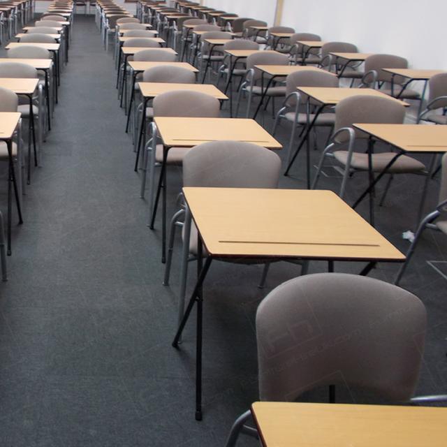 Assessments In The City https://d1hcs5uofxldvl.cloudfront.net/furniture-hire-uk/article_additional/assessments-in-the-city5/assessments-in-the-city5.jpg - Long lines of exam tables making the most of available space.