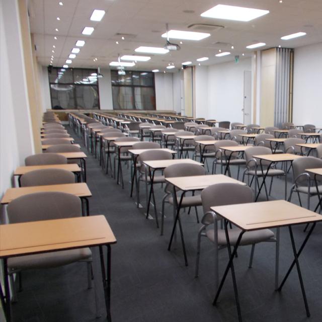 Assessments In The City https://d1hcs5uofxldvl.cloudfront.net/furniture-hire-uk/article_additional/assessments-in-the-city6/assessments-in-the-city6.jpg - Light oak exam desks look smart in corporate locations.