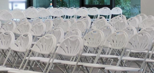 Careers Day Event https://d1hcs5uofxldvl.cloudfront.net/furniture-hire-uk/article_additional/bracknell-forest-council1/bracknell-forest-council1-740x350.jpg - White folding chairs set up in simple rows for a large meeting.