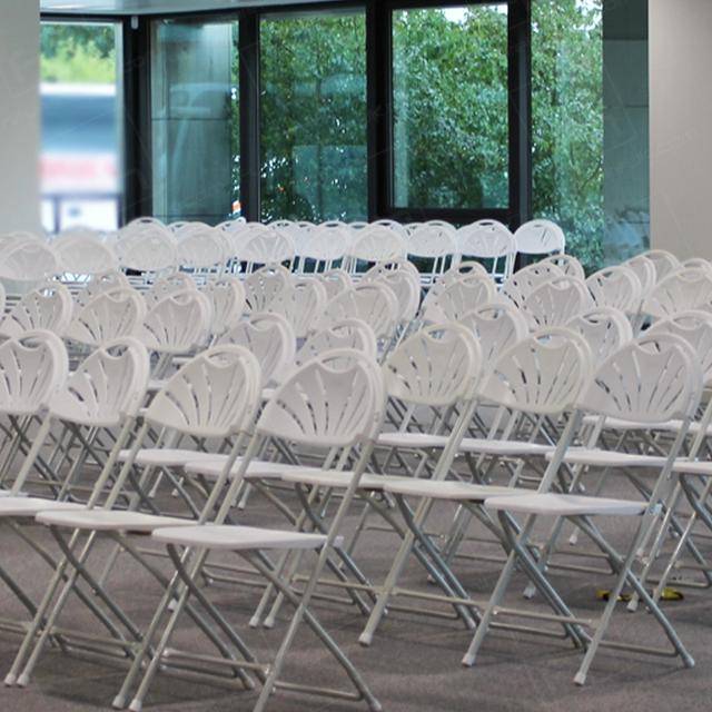 Careers Day Event https://d1hcs5uofxldvl.cloudfront.net/furniture-hire-uk/article_additional/bracknell-forest-council1/bracknell-forest-council1.jpg - White folding chairs set up in simple rows for a large meeting.