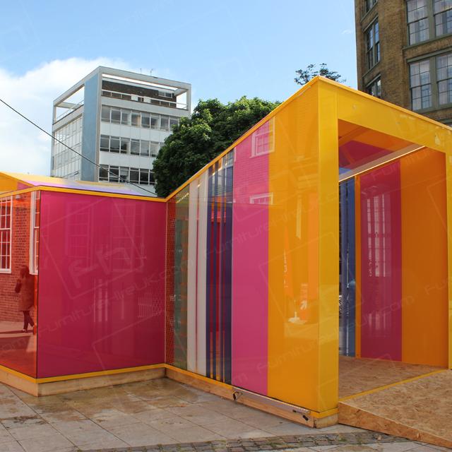 Clerkenwell Design Week https://d1hcs5uofxldvl.cloudfront.net/furniture-hire-uk/article_additional/clerkenwell-design-week2/clerkenwell-design-week2.jpg - Ultra modern glass house featuring different coloured panes of glass.