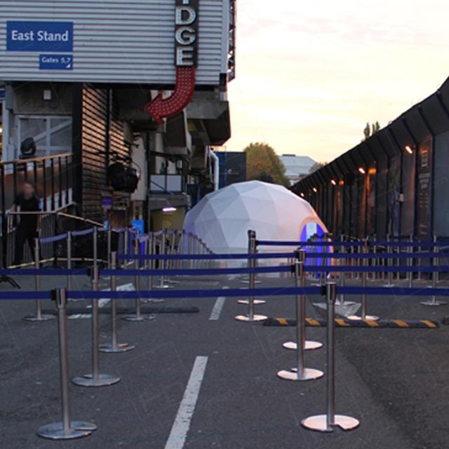 Football and Stretch Barrier Hire https://d1hcs5uofxldvl.cloudfront.net/furniture-hire-uk/article_additional/football-and-stretch-barrier-hire3/football-and-stretch-barrier-hire3.jpg - Crowd management systems set up for queuing guests.