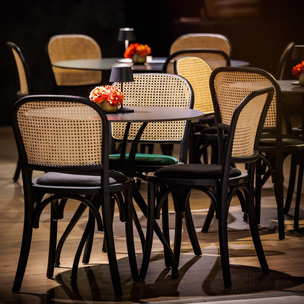 Featured: Cane back chairs with black and green pads.
