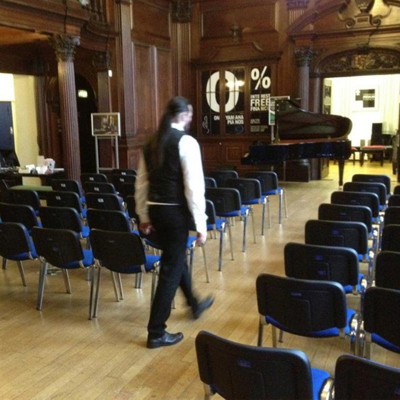 Comfy stacking chairs installed at intimate music performance.