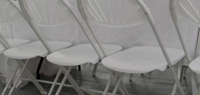 Corporate London Lunch https://mill-media.s3.eu-west-2.amazonaws.com/furniture-hire-uk/article_additional/corporate-lunch-london4/corporate-lunch-london4-740x350.jpg - Warehouse lunch complemented by white folding chairs.