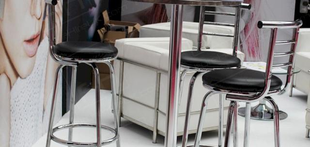 Hairdressing Exhibition https://mill-media.s3.eu-west-2.amazonaws.com/furniture-hire-uk/article_additional/hairdressing-exhibition3/hairdressing-exhibition3-740x350.jpg - Chrome tables & stools team well with white sofas.