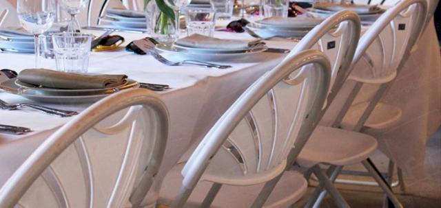 London Wedding https://mill-media.s3.eu-west-2.amazonaws.com/furniture-hire-uk/article_additional/london-wedding5/london-wedding5-740x350.jpg - Folding chairs lined up ready for guests.