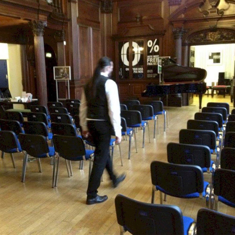 Comfy stacking chairs installed at intimate music performance.