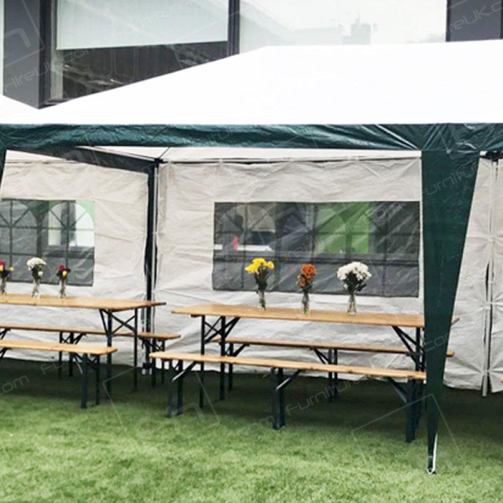 Large wooden benches and tables suitable for outdoor events.