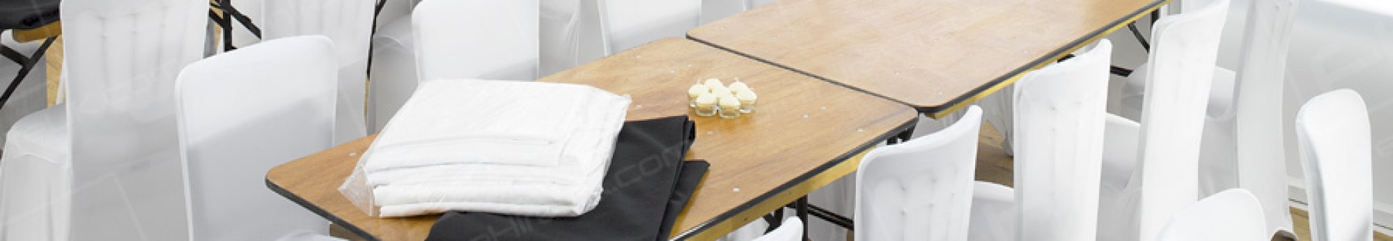 trestle table and white covered chairs